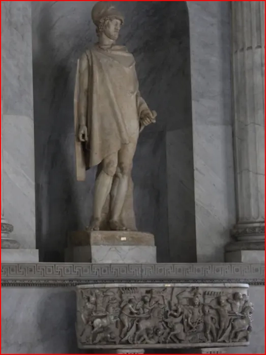 A statue of a man in a robe stands on the steps.