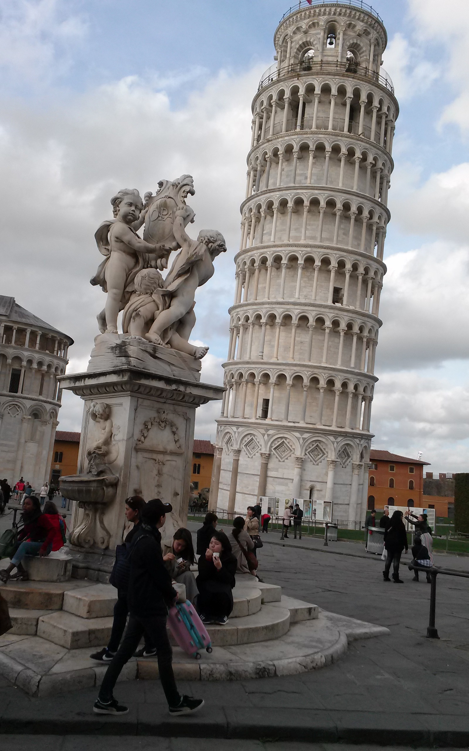 A group of people standing around in front of a tower.